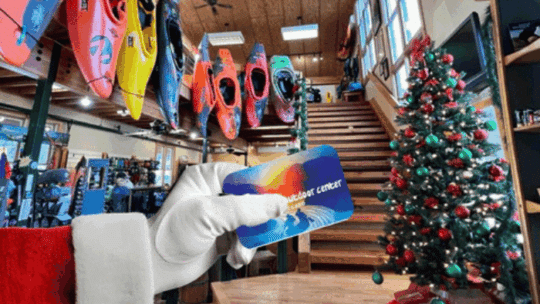 Santa arm holding a Nantahala Outdoor Center Gift Card