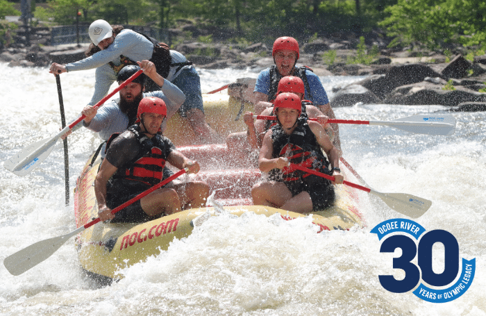 Family rafting together on the Ocoee River with Nantahala Outdoor Center guide navigating whitewater rapids